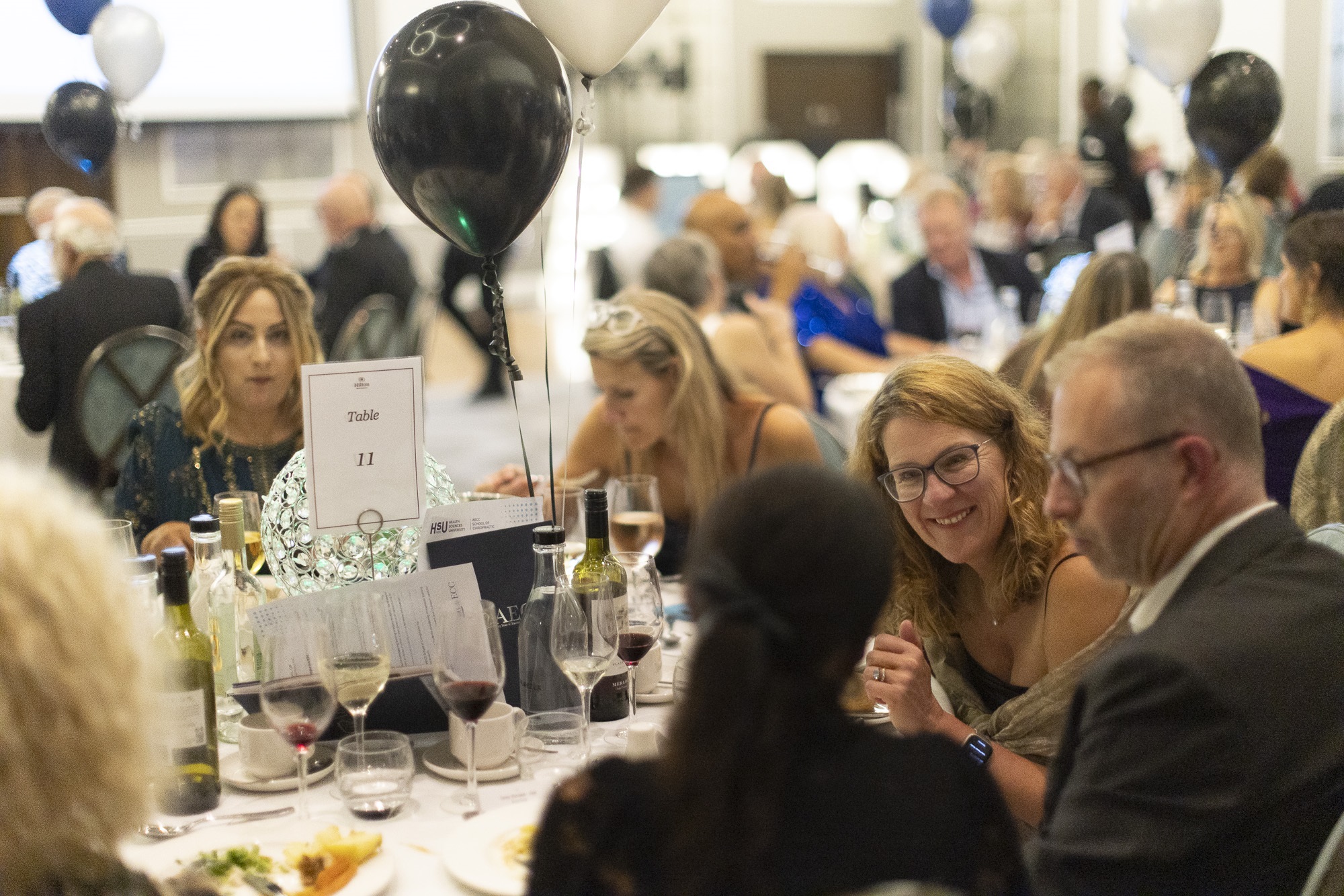 People sat around the table enjoying the event.